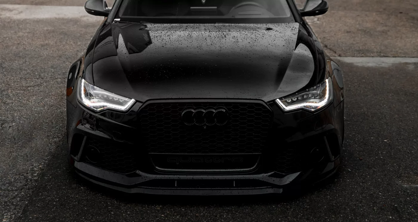 Black Audi with rain drops on the hood.